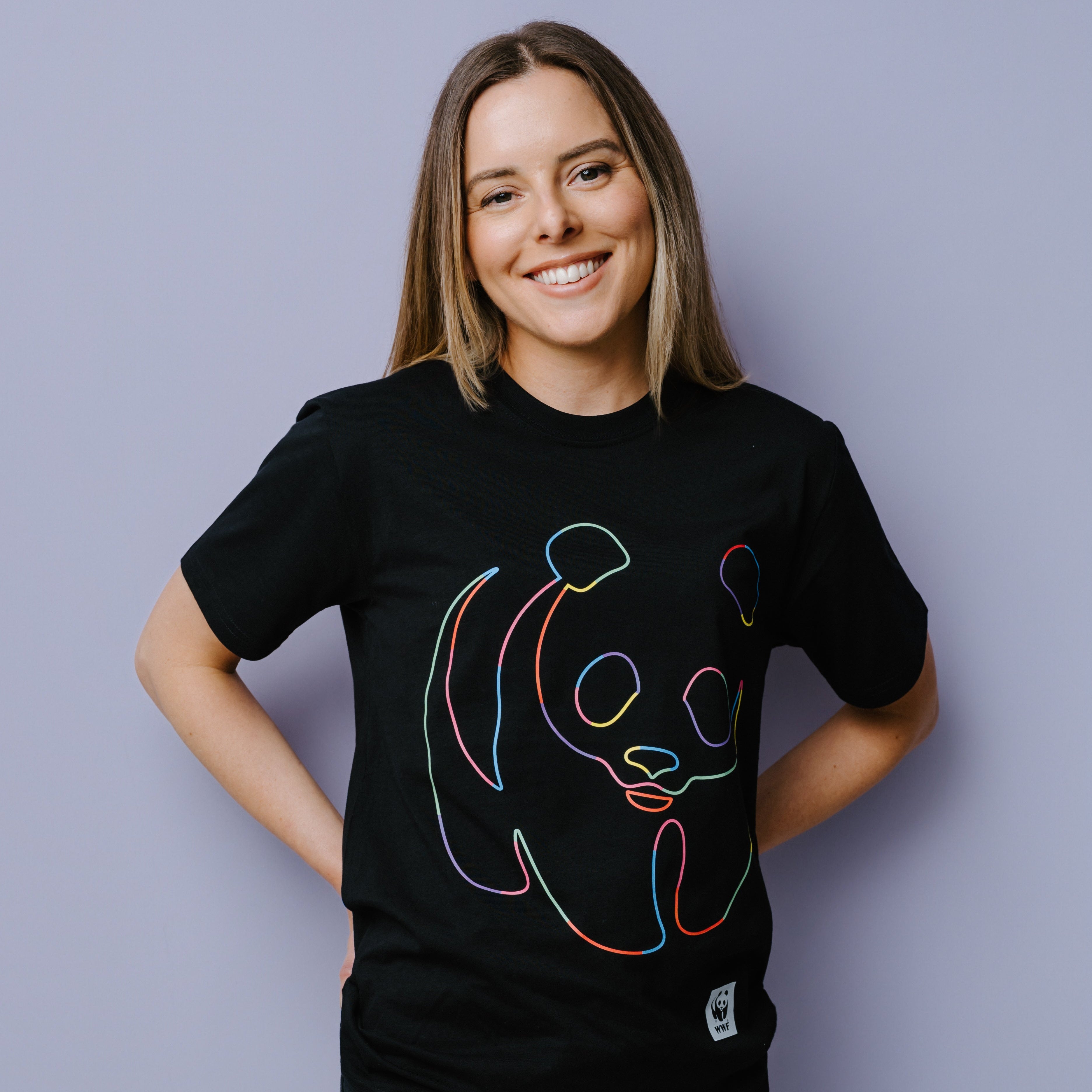 Person wearing a black t-shirt with rainbow WWF panda logo design on a plain background.