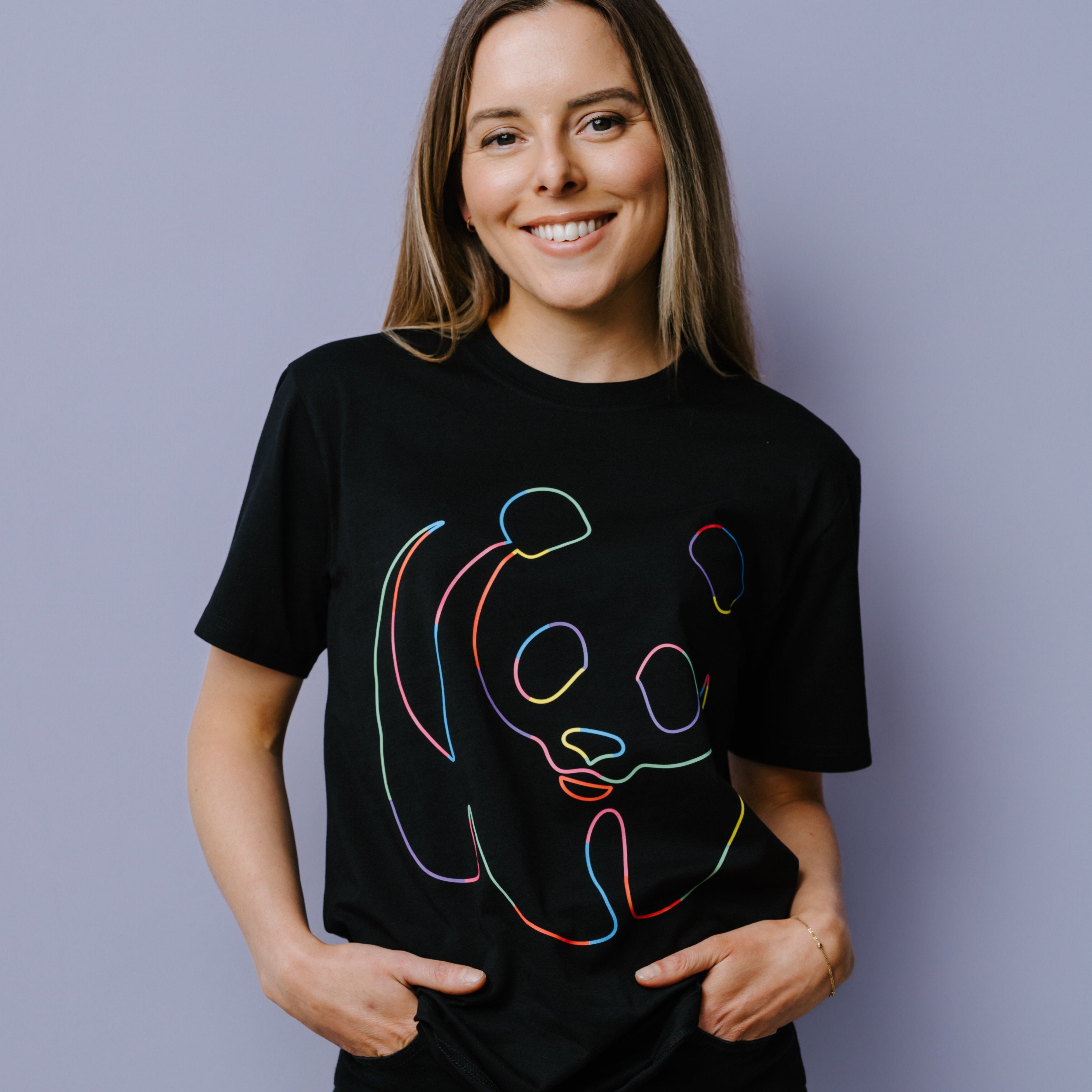 Person wearing a black t-shirt with rainbow WWF panda logo design on a plain background.
