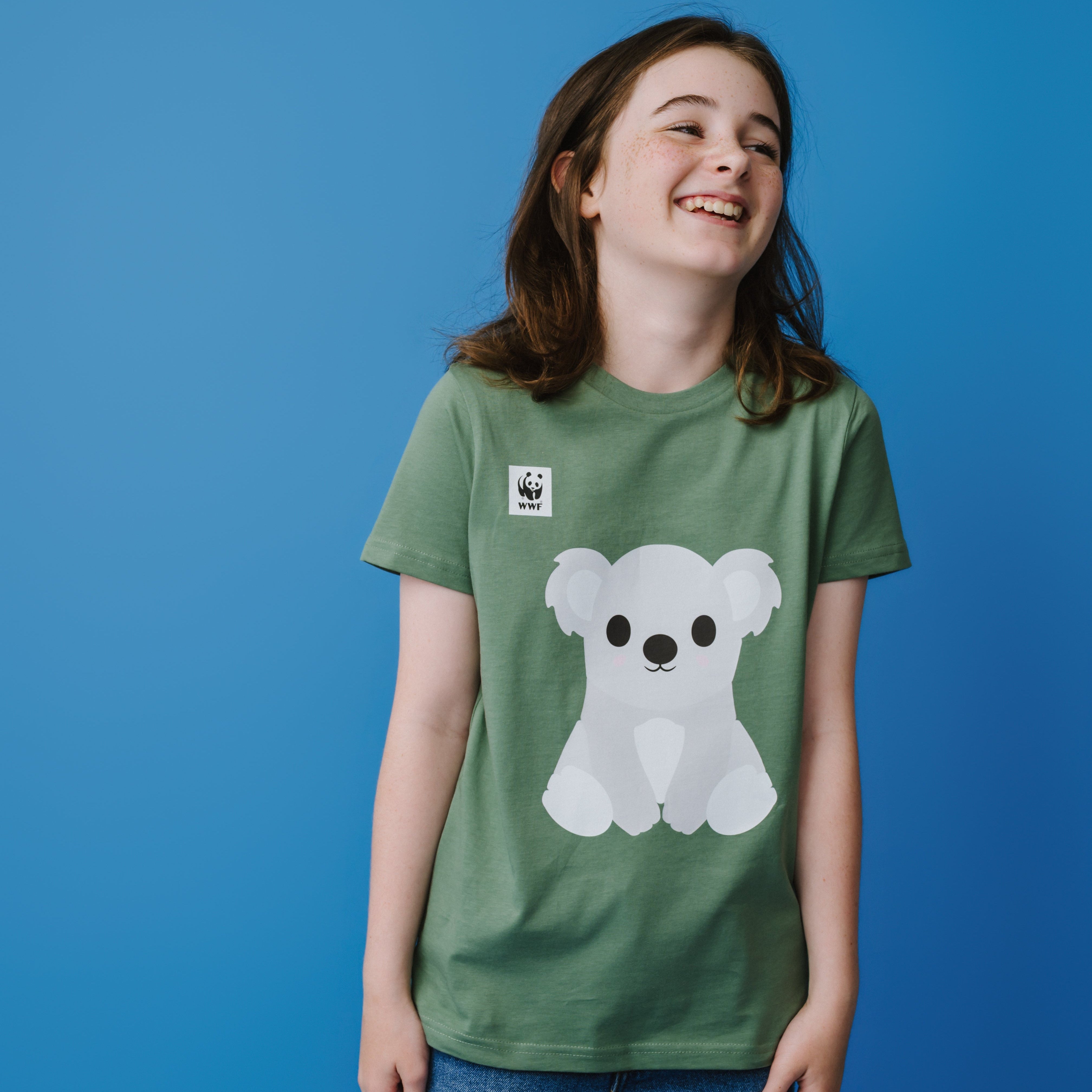 Person wearing a green t-shirt with a light grey and white koala design on a blue background.