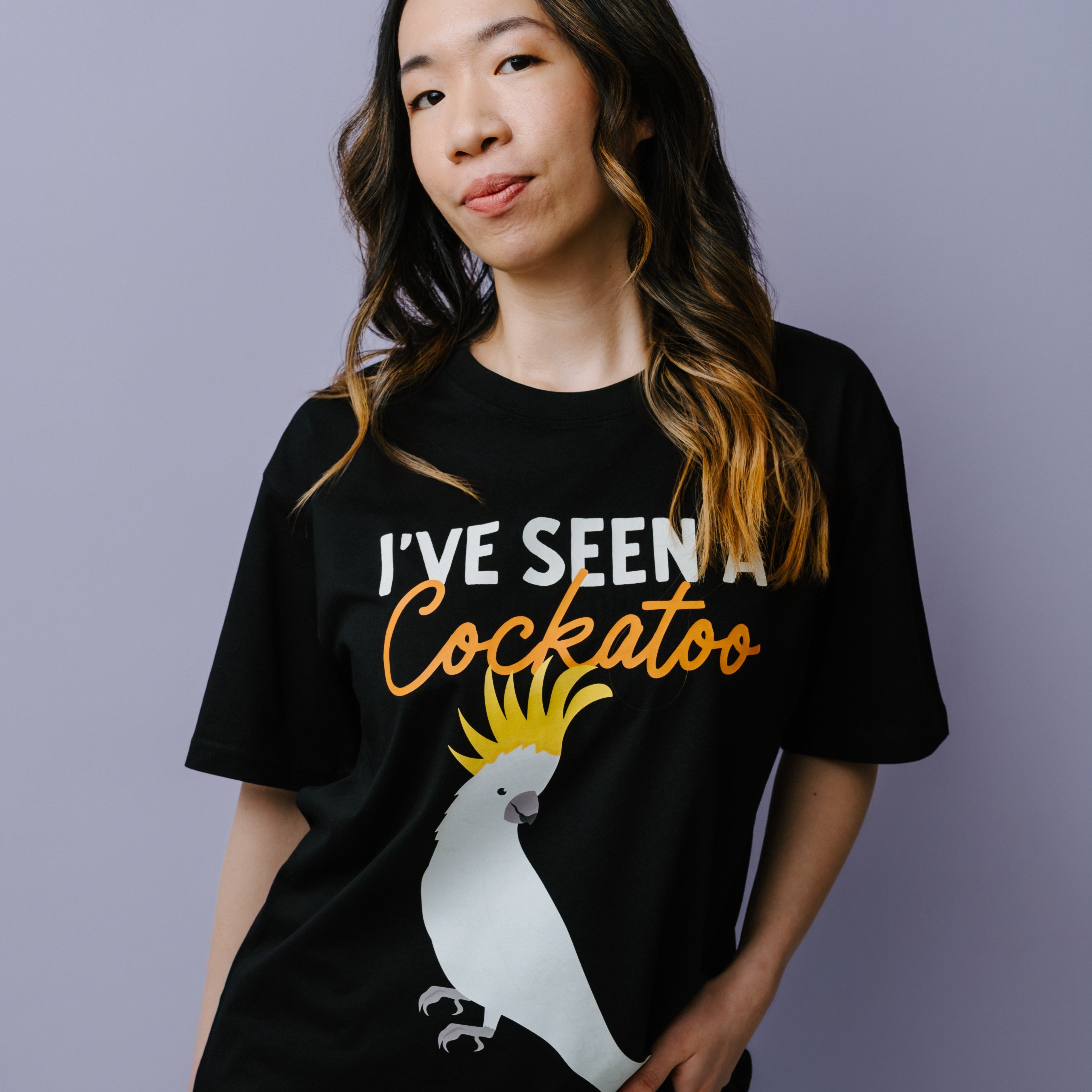 Person wearing a black t-shirt with a graphic and text, standing against a plain background. WWF-Australia cockatoo t-shirt.